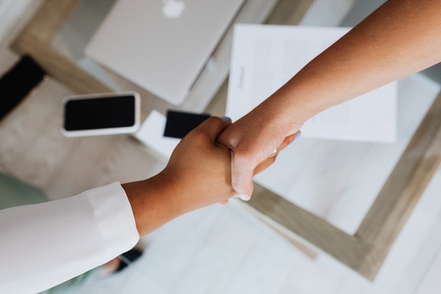 people%20shaking%20hands%20across%20a%20desk%20with%20a%20contract%20on%20it people%20shaking%20hands%20across%20a%20desk%20with%20a%20contract%20on%20it